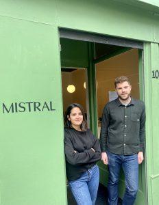 A man and woman standing outside of a Mistral shop