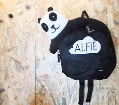 Panda shaped rucksack hanging with the name Alfie written within a cloud shape