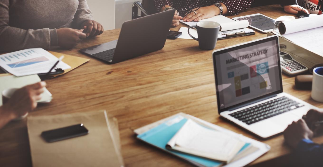 People sitting at a desk discussing marketing strategy